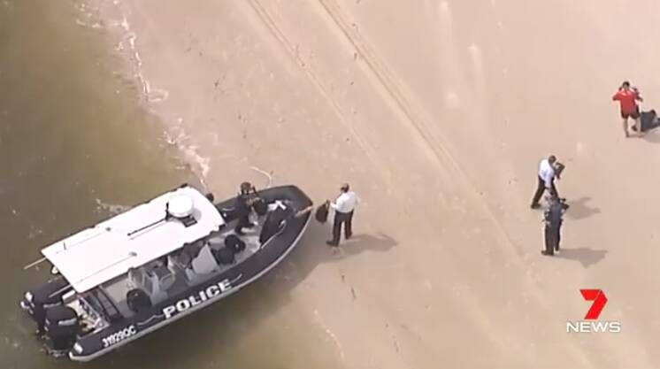 Police arrive at the beach on the northern tip of Bribie Island where the bodies were found. Photo: 7 News Brisbane - Twitter