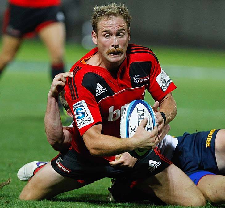 Andy Ellis of the Crusaders is tackled by Josh Valentine of the Brumbies. Photo: Getty Images