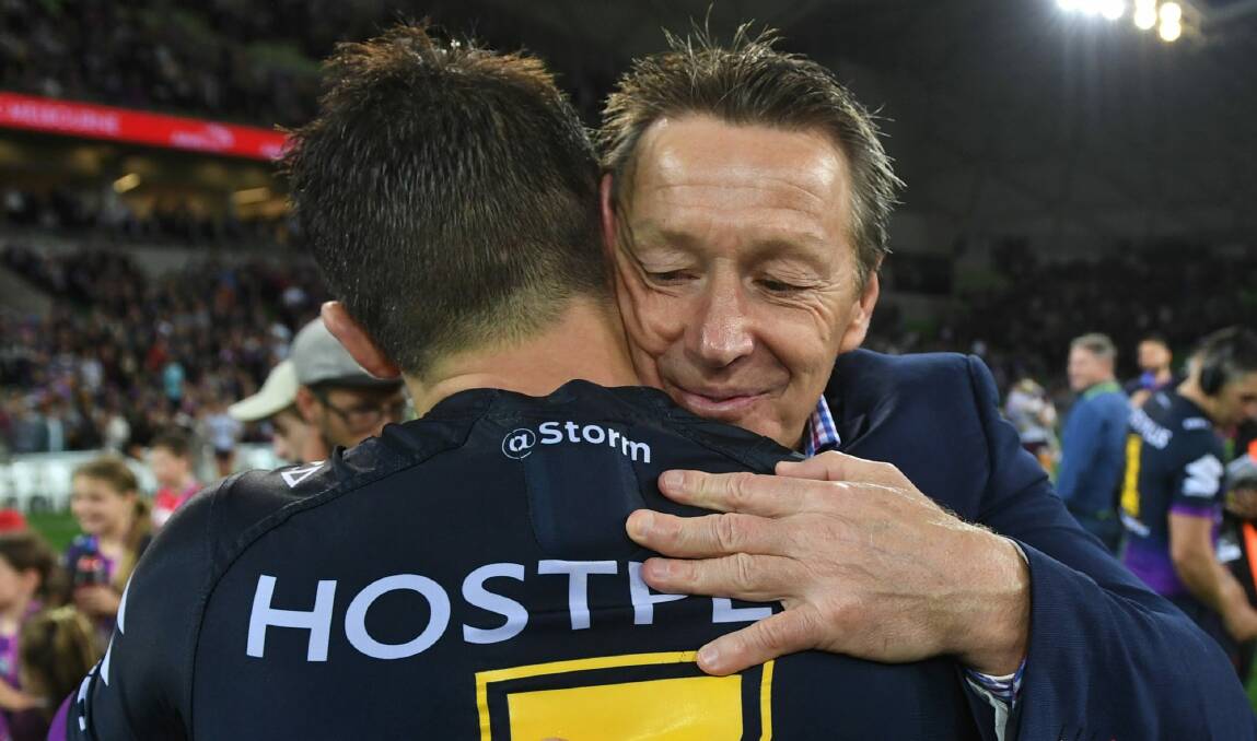 End of an era: Craig Bellamy with Cooper Cronk. Photo: AAP 