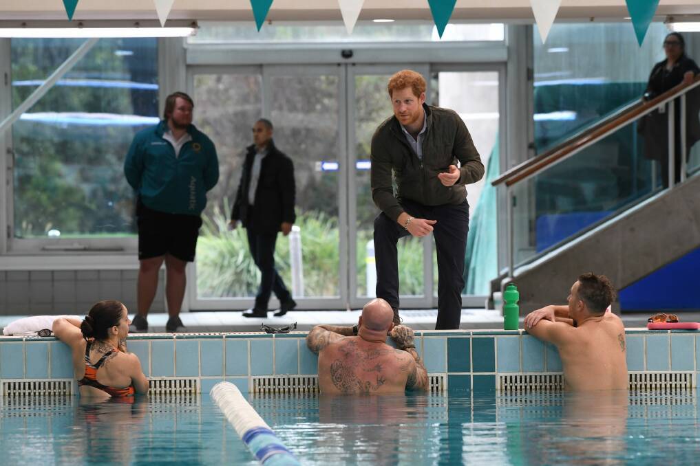 Prince Harry meets defence veteran swimmers after touring the Sydney International Aquatic Centre, where the Invictus Games will be held in 2018. Photo: Louise Kennerley