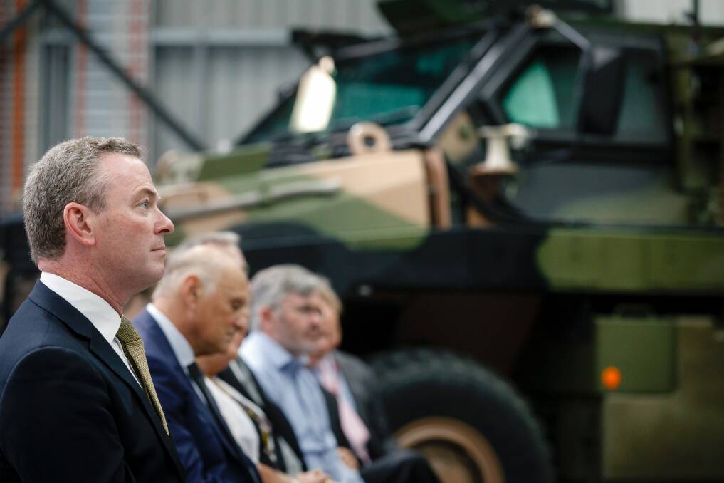 Defence Minister Christopher Pyne in front of an Australian bushmaster at the opening of a new weapons systems manufacturing facility in Hume on Tuesday.  Photo: Sitthixay Ditthavong