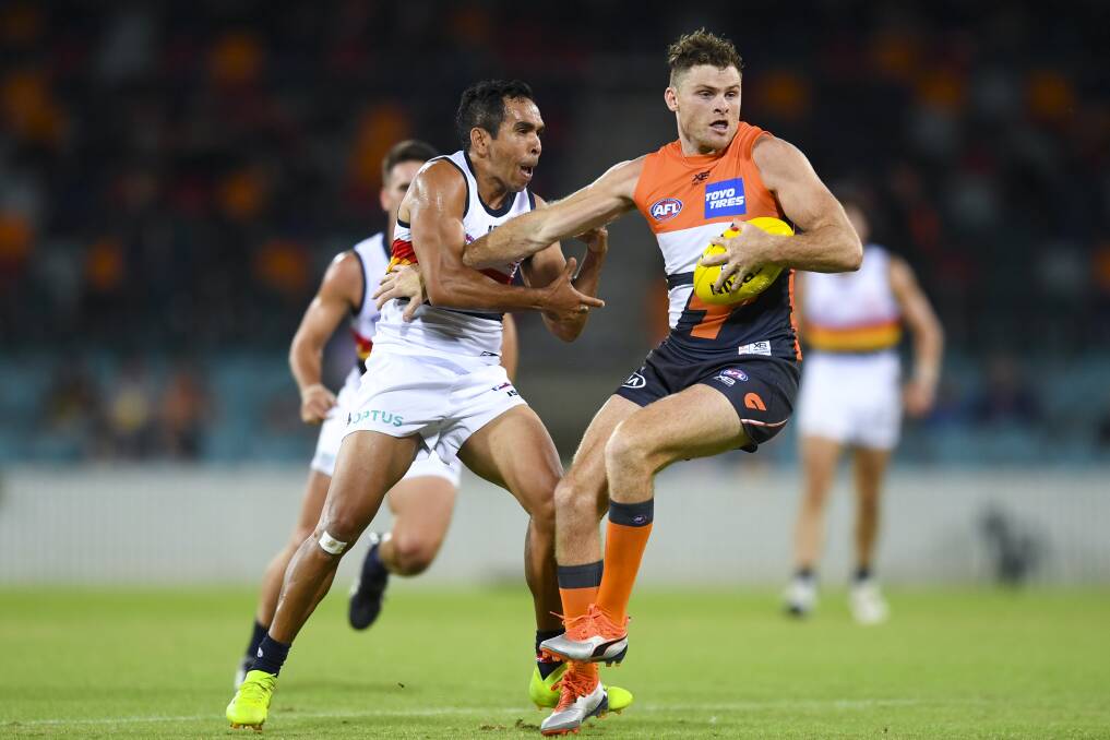 Eddie Betts of the Crows (left) fights for the ball with Heath Shaw of the Giants. Photo: Lukas Coch