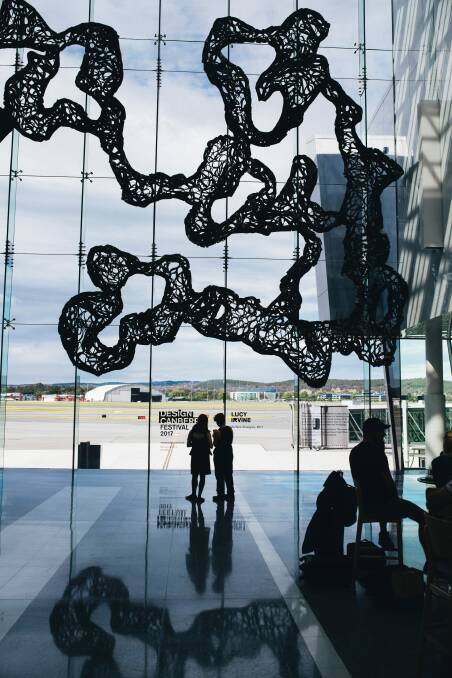 Lucy Irvine with her work, Surface Strategies, which has been installed at the Canberra Airport as part of the Design Canberra Festival. Photo: Rohan Thomson