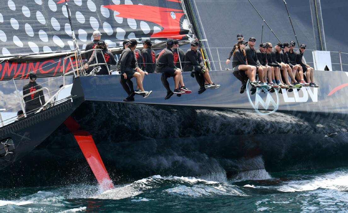 Expected leaders: The crew of LDV Comanche sit on its side during a practice sail. Photo: AAP