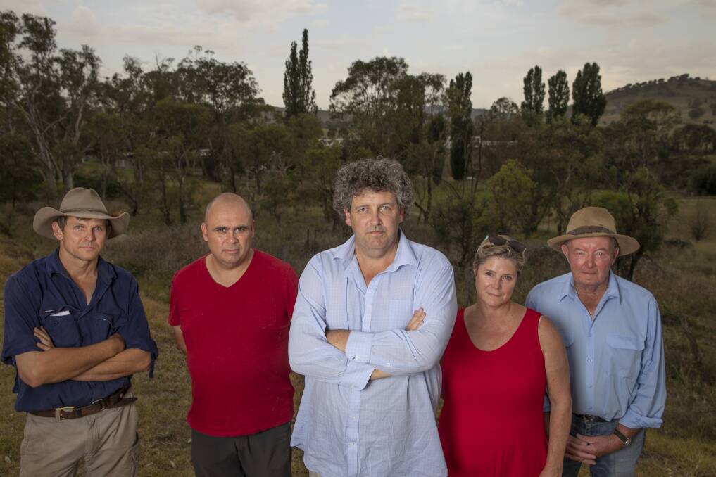 Tharwa residents, from left, Myles Gostelow, Karim Haddad, Kevin Jeffery, Janet Flint and Michael Lonergan stand near the site of a proposed firefighting water supply on the Murrumbidgee River. Photo: Sitthixay Ditthavong