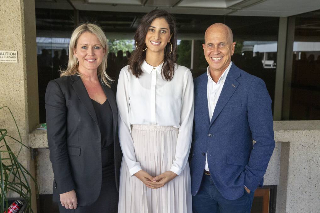Lamisse Hamouda, daughter of Hazem Hamouda is seen posing for photograph alongside journalist Peter Greste (right) and her family's lawyer Jennifer Robinson(left) at Queensland Parliament House in Brisbane on Thursday. Photo: AAP