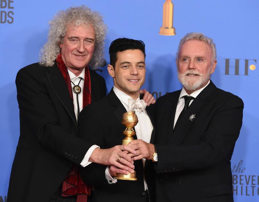 Brian May, left, and Roger Taylor, right, of Queen, and Rami Malek with the award for best motion picture, drama, for "Bohemian Rhapsody" at the 76th annual Golden Globe Awards 2019.  Photo: Jordan Strauss