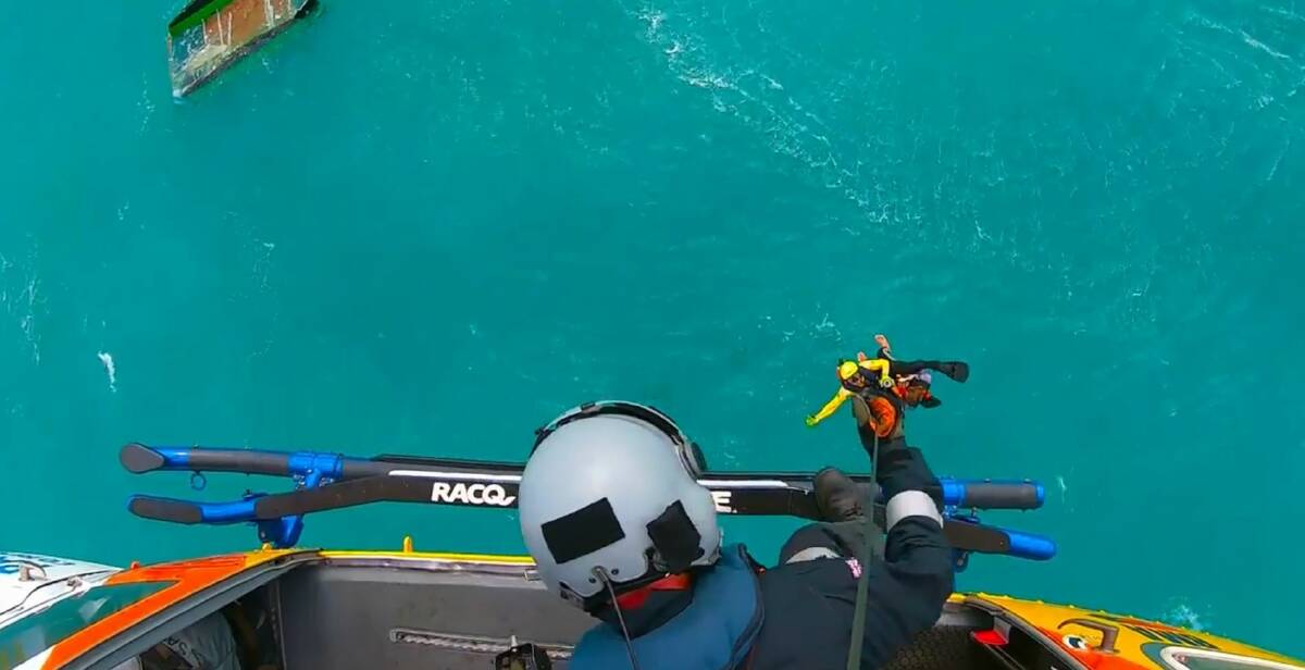 RACQ CQ Rescue winches American tourist Levi Verwoest from his overturned catamaran near Cape Palmerston, Koumala, Queensland. Photo: RACQ CQ Rescue