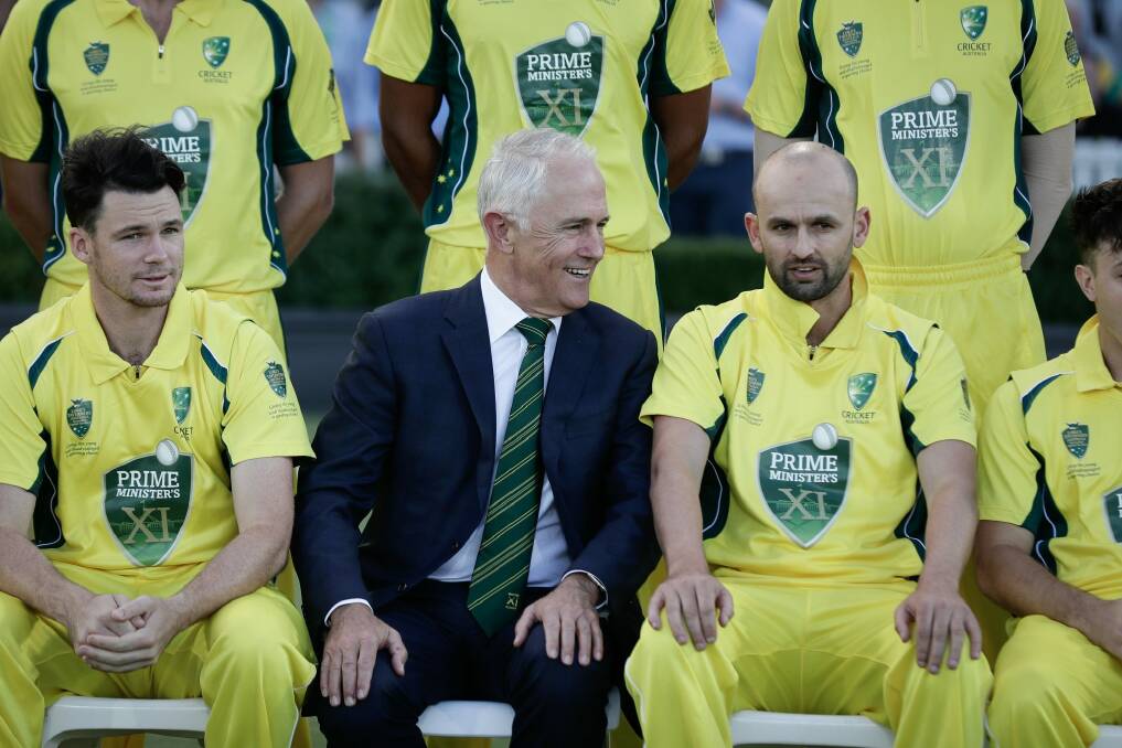 Prime Minister Malcolm Turnbull speaks with captain Nathan Lyon during a team ahead of the PM's XI cricket match against England earlier this year. Photo: Alex Ellinghausen