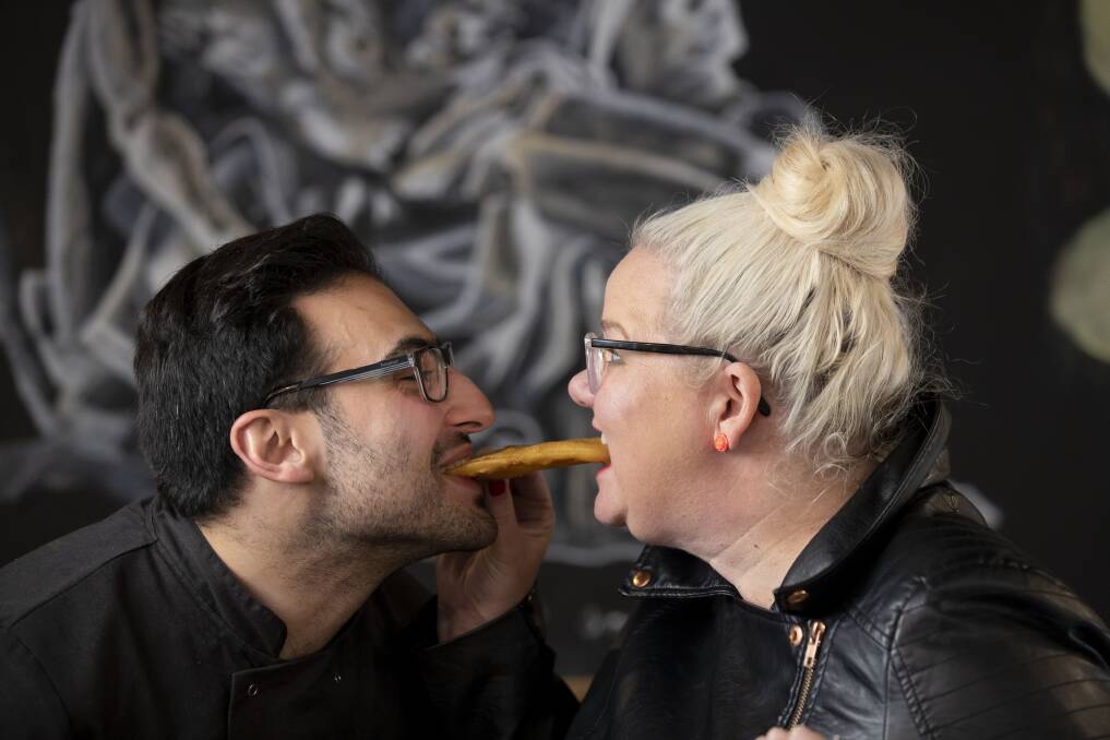 Anthony and I re-enact a scene from 'Lady and the Tramp' with a potato scallop.  Photo: Sitthixay Ditthavong