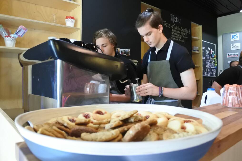 Black Mountain School year 11 student Michael Levi makes a coffee at new cafe Six Degrees. Photo: Emily Baker