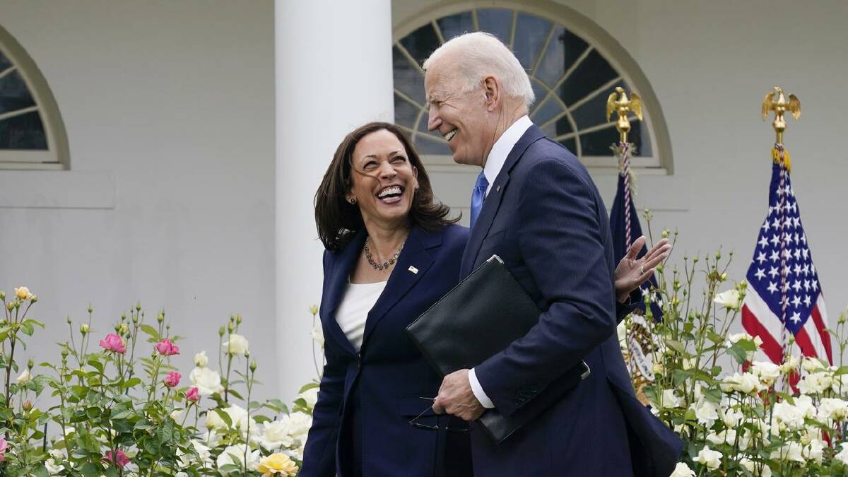 President Joe Biden walks with Vice President Kamala Harris in the White House grounds. (AP PHOTO)