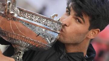 Carlos Alcaraz kisses the trophy after winning the French Open, his third grand slam triumph. (AP PHOTO)