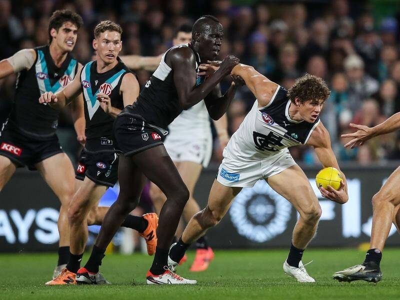 Port's Aliir Aliir earned a holding-the-ball free kick for this tackle on Carlton's Charlie Curnow. (Matt Turner/AAP PHOTOS)