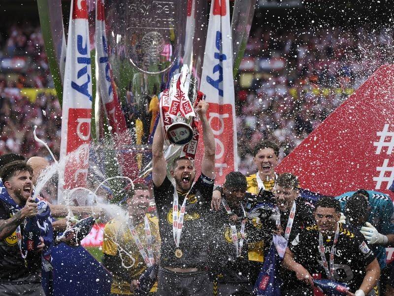 Southampton's Jack Stephens lifts the trophy above his teammates after their Wembley triumph. (AP PHOTO)
