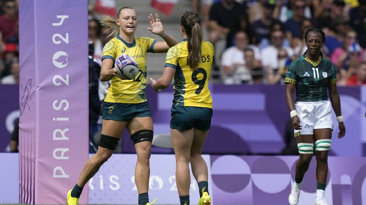 Australia's Maddison Levi and Tia Hinds celebrate a try in the sevens win over South Africa. (AP PHOTO)