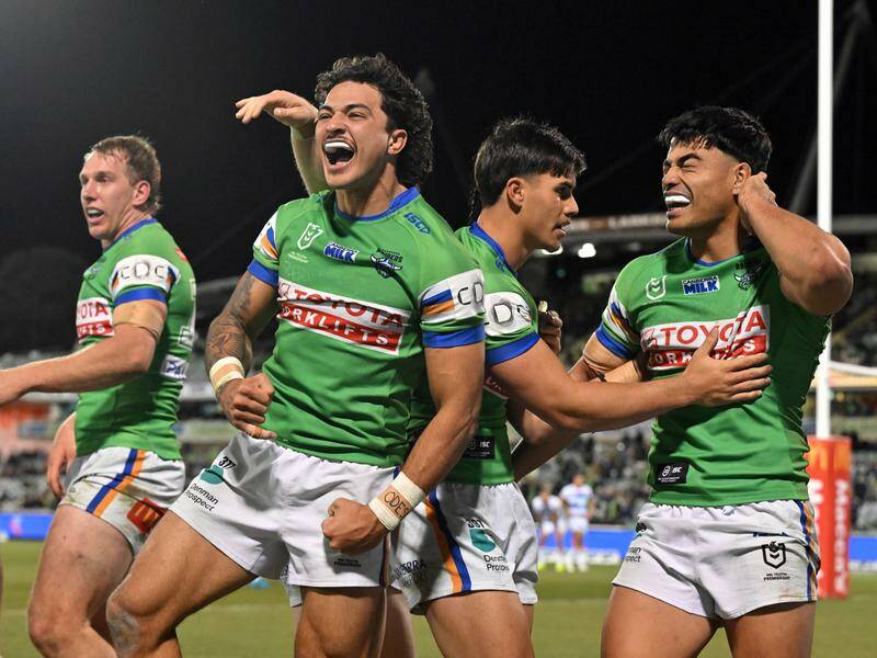 Raiders' Xavier Savage celebrates after scoring a try against the Warriors in chilly Canberra. Photo: Mick Tsikas/AAP PHOTOS