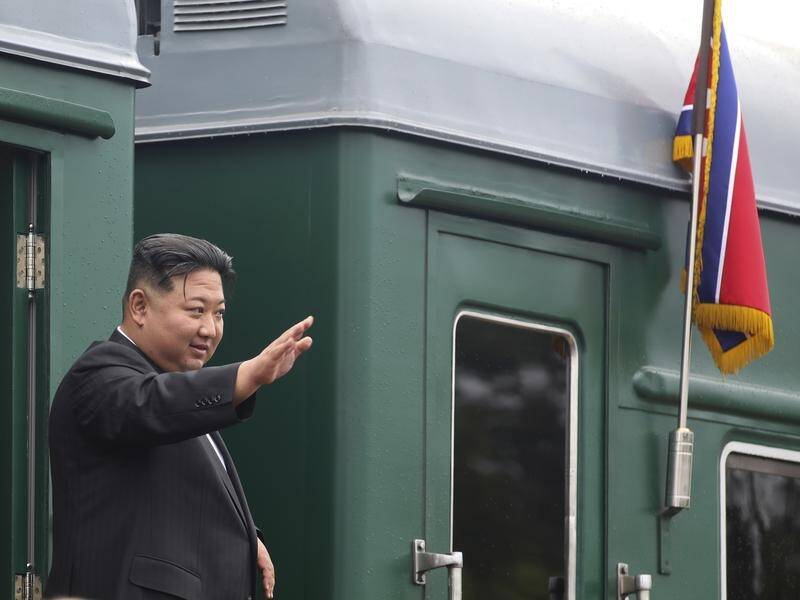 North Korea's Kim Jong-un waves as he boards his train near Vladivostok in Russia's far east (AP)