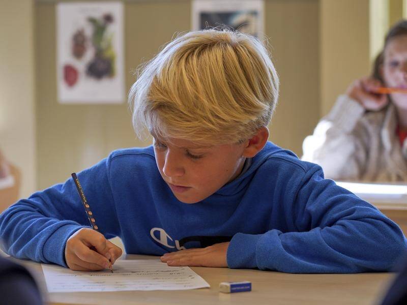 A boy practices handwriting at the Djurgardsskolan elementary school in Stockholm. (AP)