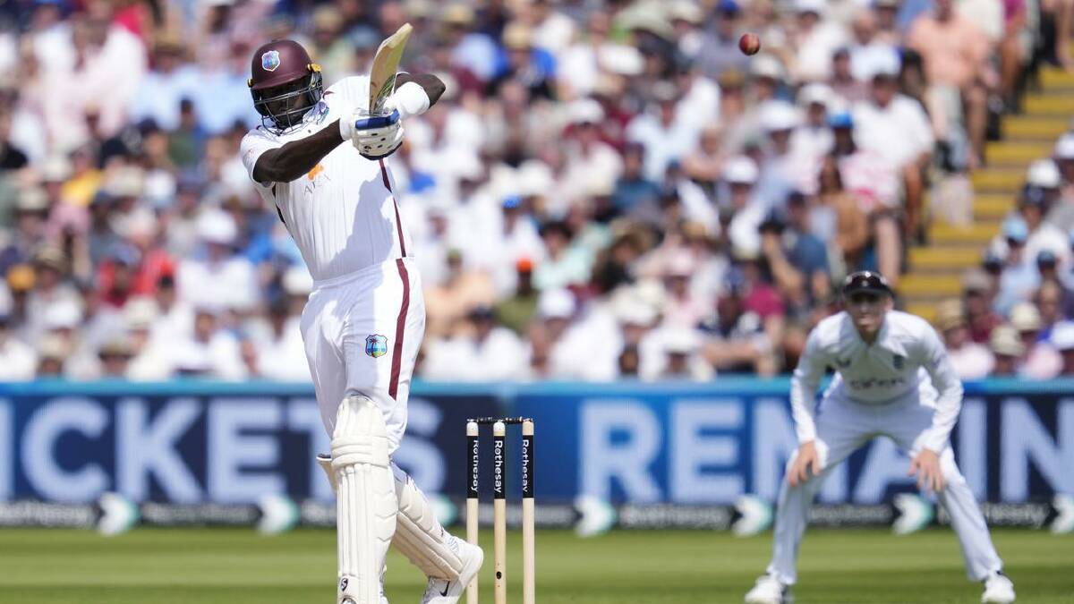 West Indies' Jason Holder smashes a boundary on day three of the third Test in Birmingham. (AP PHOTO)