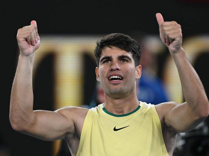 It's thumbs up for Carlos Alcaraz as the Spaniard launched his Australia Open campaign with a win. (Lukas Coch/AAP PHOTOS)