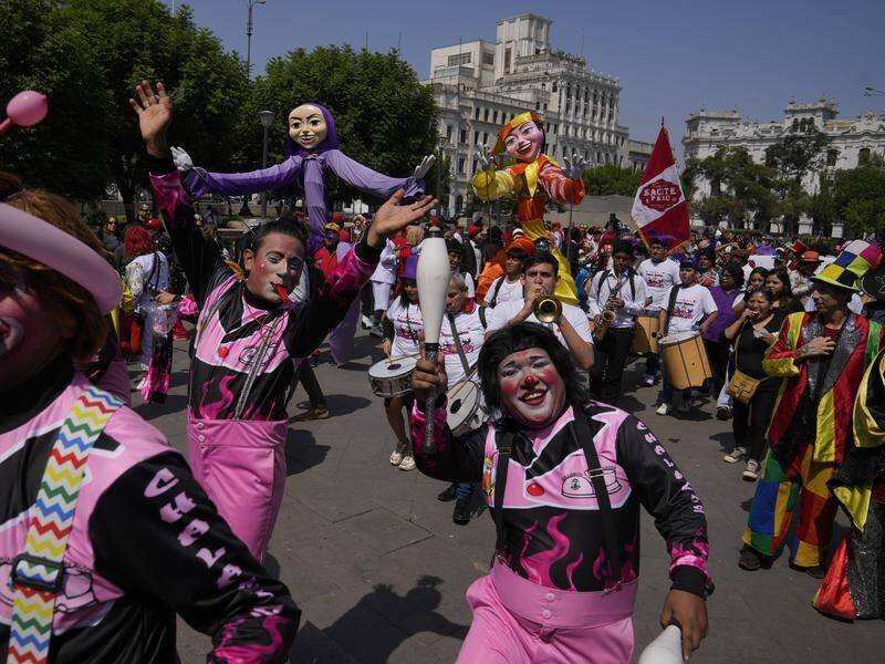 Colourful clowns celebrate Clown Day in Lima's San Martin plaza. (AP PHOTO)