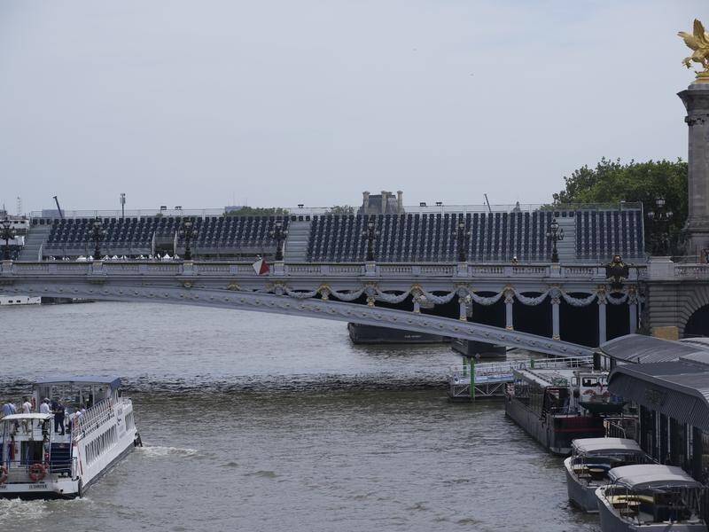 A tourist barge passes under the Alexandre III bridge on the still contaminated River Seine. (AP PHOTO)