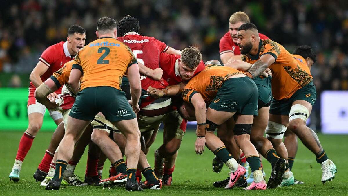 Wallabies forwards do their best to halt a Welsh drive last time out in Melbourne. (James Ross/AAP PHOTOS)