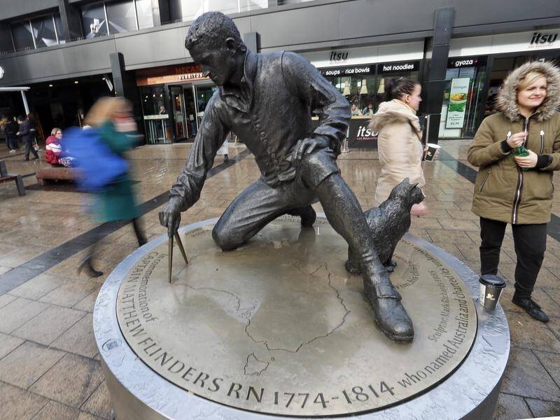 A statue of Matthew Flinders and his cat stands at Euston station near where his grave was found. (AP PHOTO)