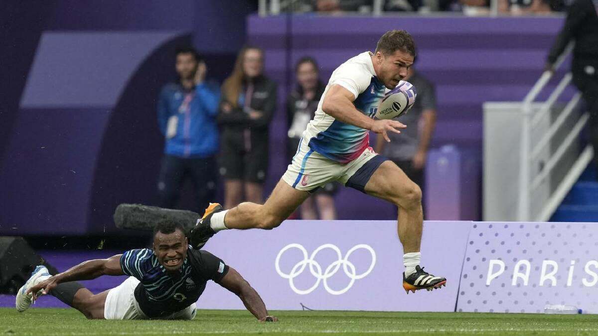 Antoine Dupont races clear to score a try and win gold for France in the Rugby Sevens over Fiji. (AP PHOTO)
