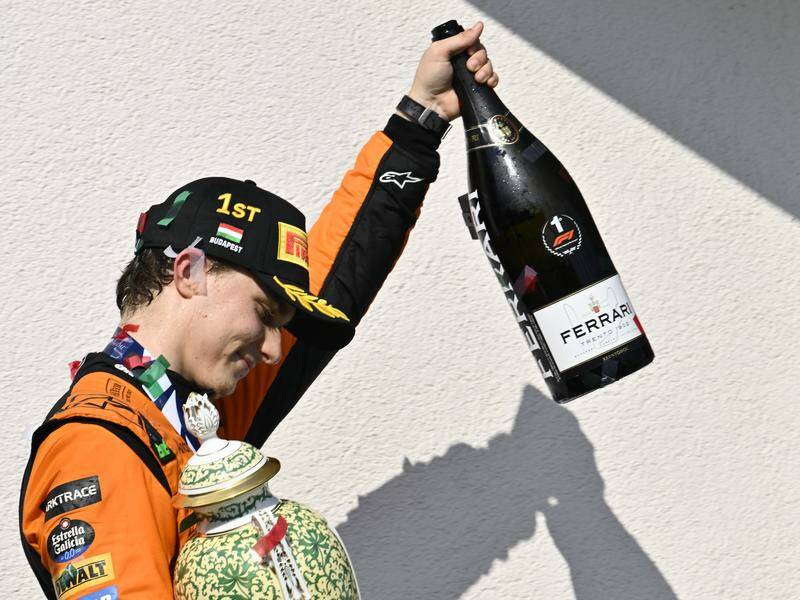 Oscar Piastri celebrates after his maidenHungarian F1 win.. but there was no Champagne shoey! Photo: AP PHOTO