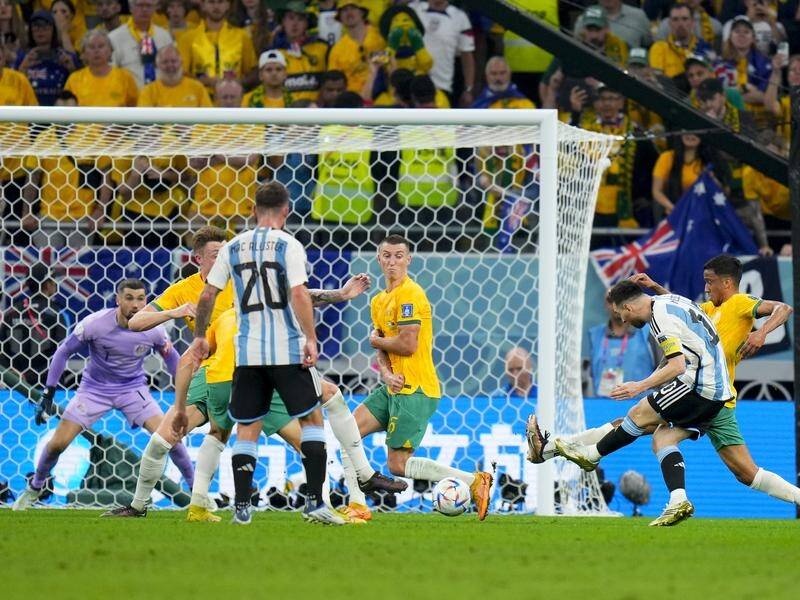 Lionel Messi scores the opening goal of Argentina's 2-1 win over the Socceroos. (AP PHOTO)