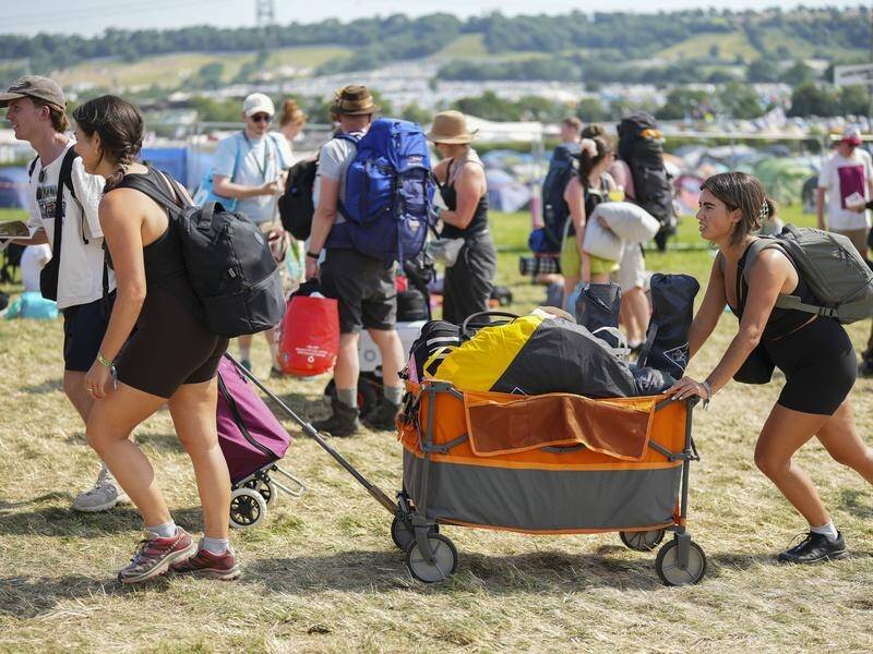 Sunny weather has welcomed fans who arrived at Glastonbury carrying rucksacks and camping gear. (AP PHOTO)