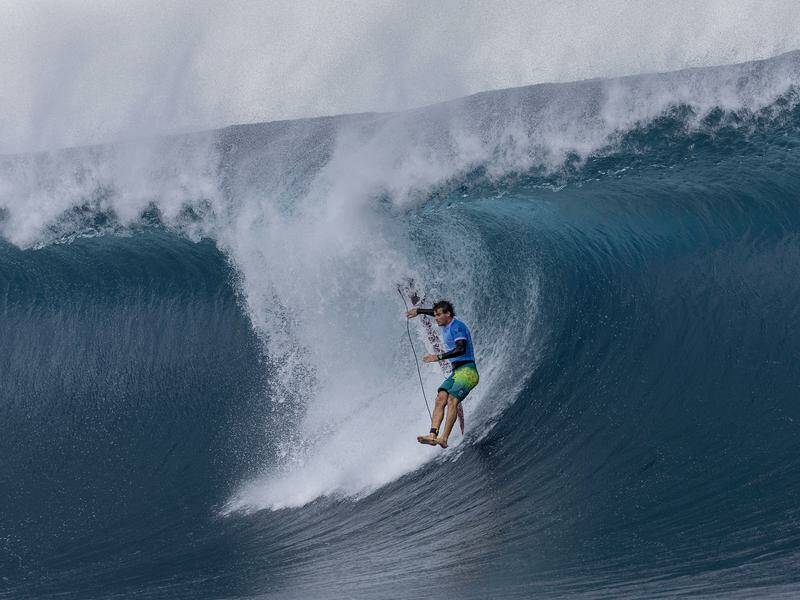 Jack Robinson bails in Teahupo'o wild surf before prevailing in his Olympic surfing heat. Photo: AP PHOTO