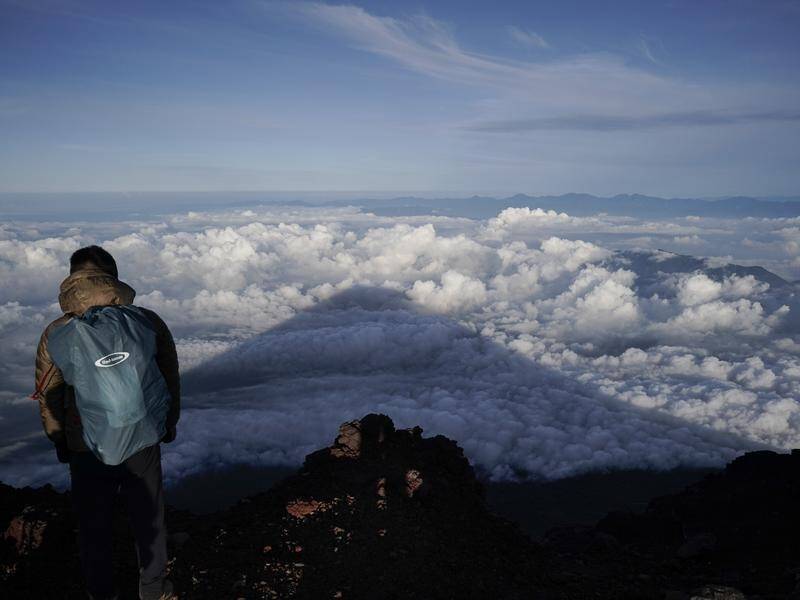 Cold temperatures and altitude sickness are risks for the thousands who scale Mount Fuji every year. (AP PHOTO)