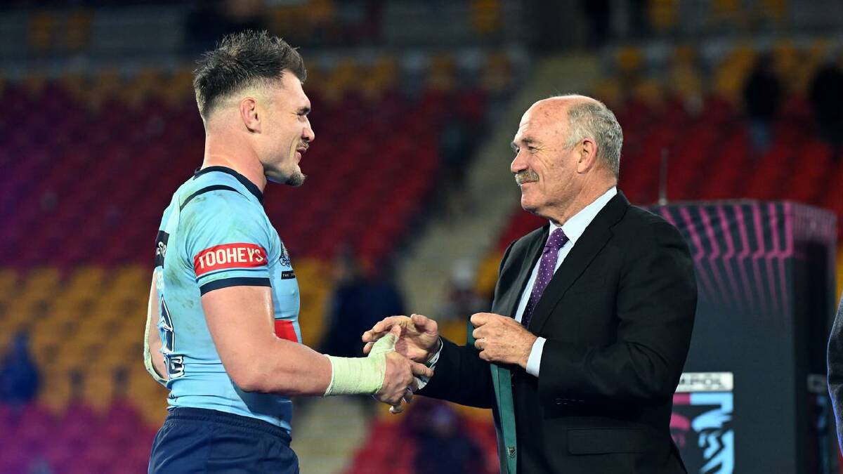Angus Crichton receives the Wally Lewis Medal from the man himself. (Darren England/AAP PHOTOS)