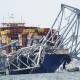 "The best minds in the world" are working to clear bridge debris and move the cargo ship. (AP PHOTO)