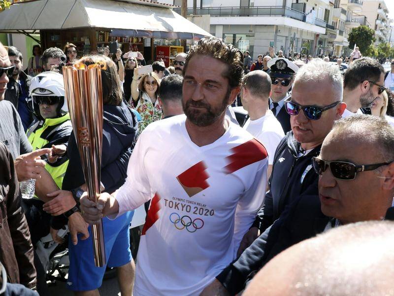 Actor Gerard Butler was an Olympic torchbearer before the Greek legs were called off on Friday.