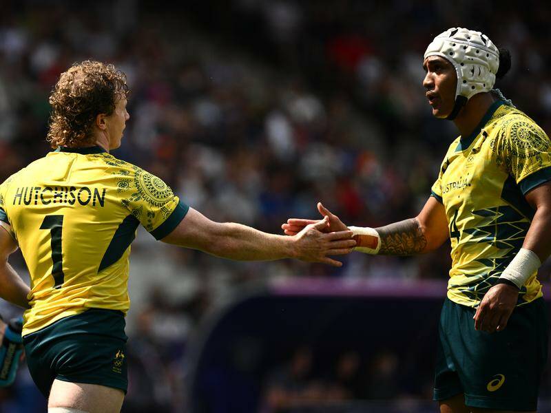 Henry Hutchison and Dietrich Roache celebrate a try in Australia's narrow win over Samoa. Photo: Dan Himbrechts/AAP PHOTOS