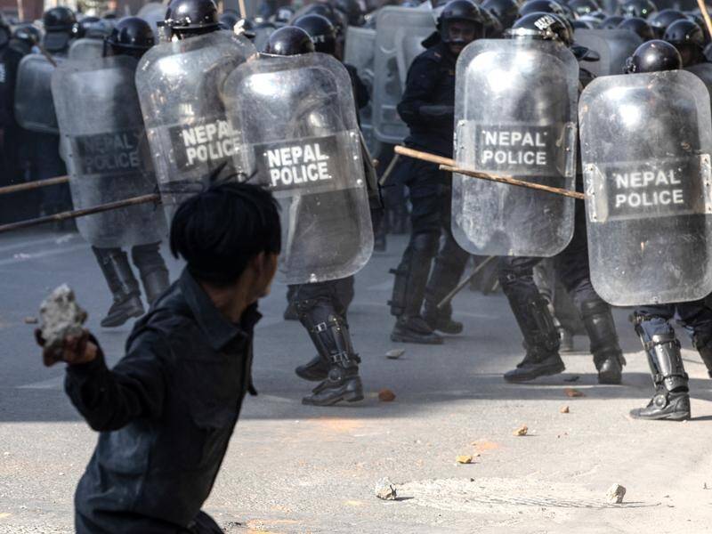 Monarchist protesters tried to dismantle a police barricade in Kathmandu, witnesses say. (EPA PHOTO)