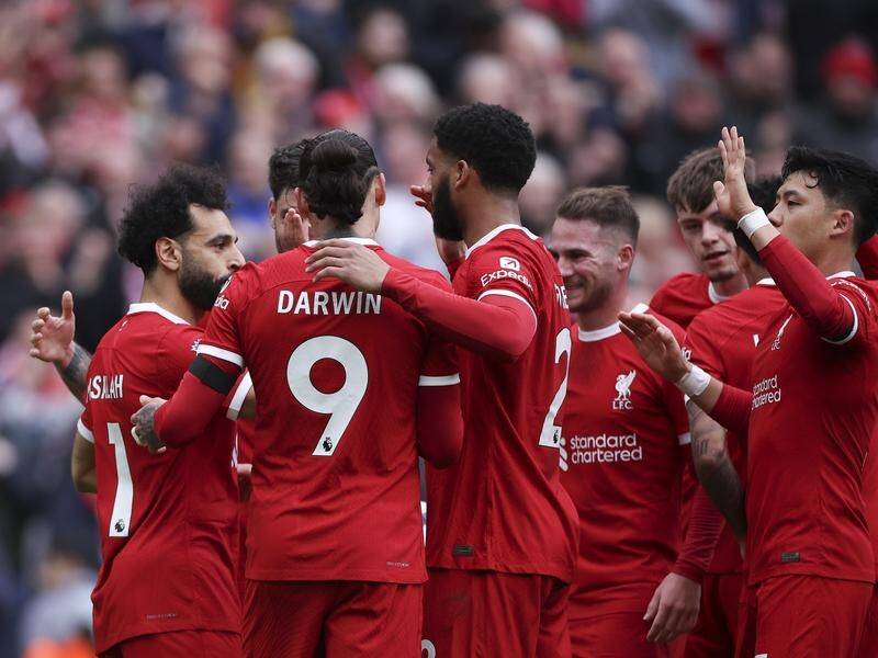 Mo Salah (l) takes the congratulations of his teammates after putting Liverpool top of the league. (EPA PHOTO)