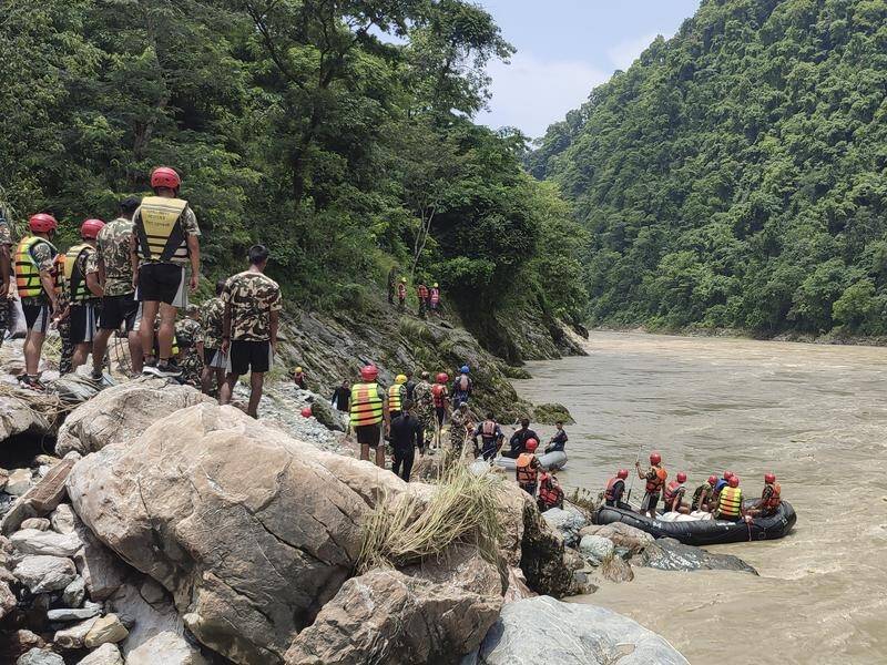 Searchers found bodies that had been washed as far as 100km down the Trishuli River. (AP PHOTO)