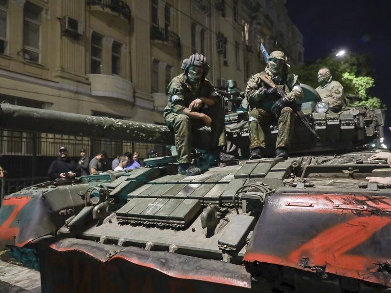 Members of the Wagner Group military company sit atop a tank on a street in Rostov. (AP PHOTO)