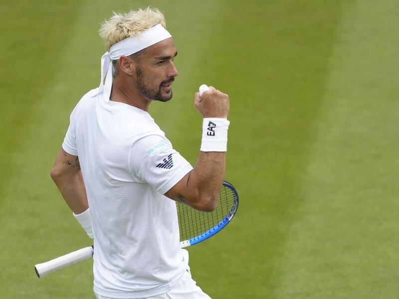 Fabio Fognini flexes his bicep in celebration after winning a point in his win over Casper Ruud. (AP PHOTO)