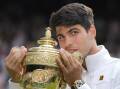 Carlos Alcaraz clutches the Wimbledon men's singles trophy again after a fabulous win. (AP PHOTO)