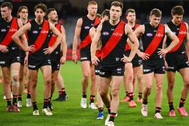 Zach Merrett leads off the disappointed Bombers players after the 26-point loss to the Blues. (Morgan Hancock/AAP PHOTOS)