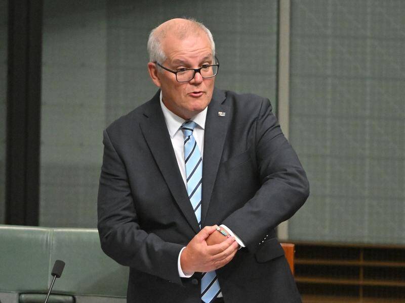 Scott Morrison shows off his Taylor Swift bracelet during his valedictory speech in parliament. (Mick Tsikas/AAP PHOTOS)