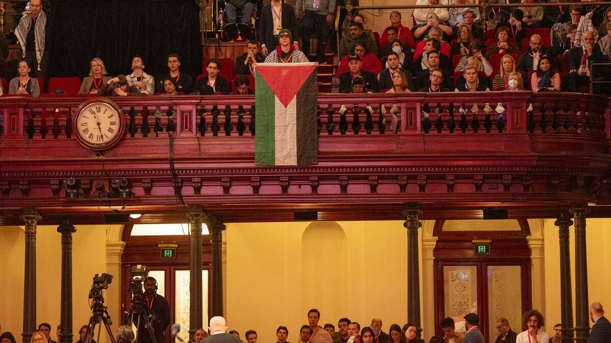 The Palestinian flag is shown by a member during Anthony Albanese's NSW Labor conference address. (Jeremy Piper/AAP PHOTOS)