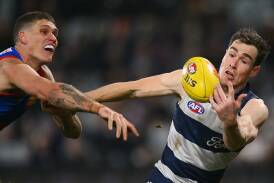 Jeremy Cameron (r) says Geelong are still in the mix despite being soundly beaten by the Bulldogs. Photo: Morgan Hancock/AAP PHOTOS