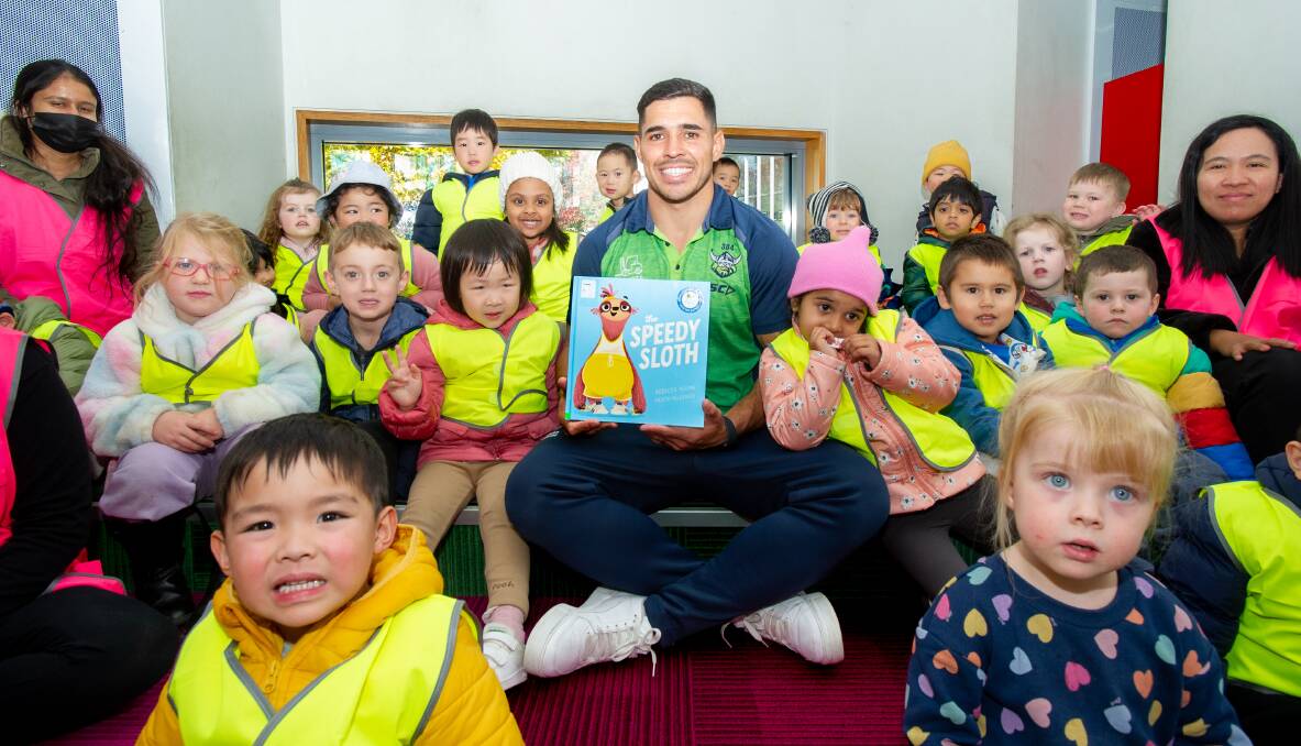 Canberra Raiders star Jamal Fogarty and his listeners at Gungahlin library. Picture by Sitthixay Ditthavong